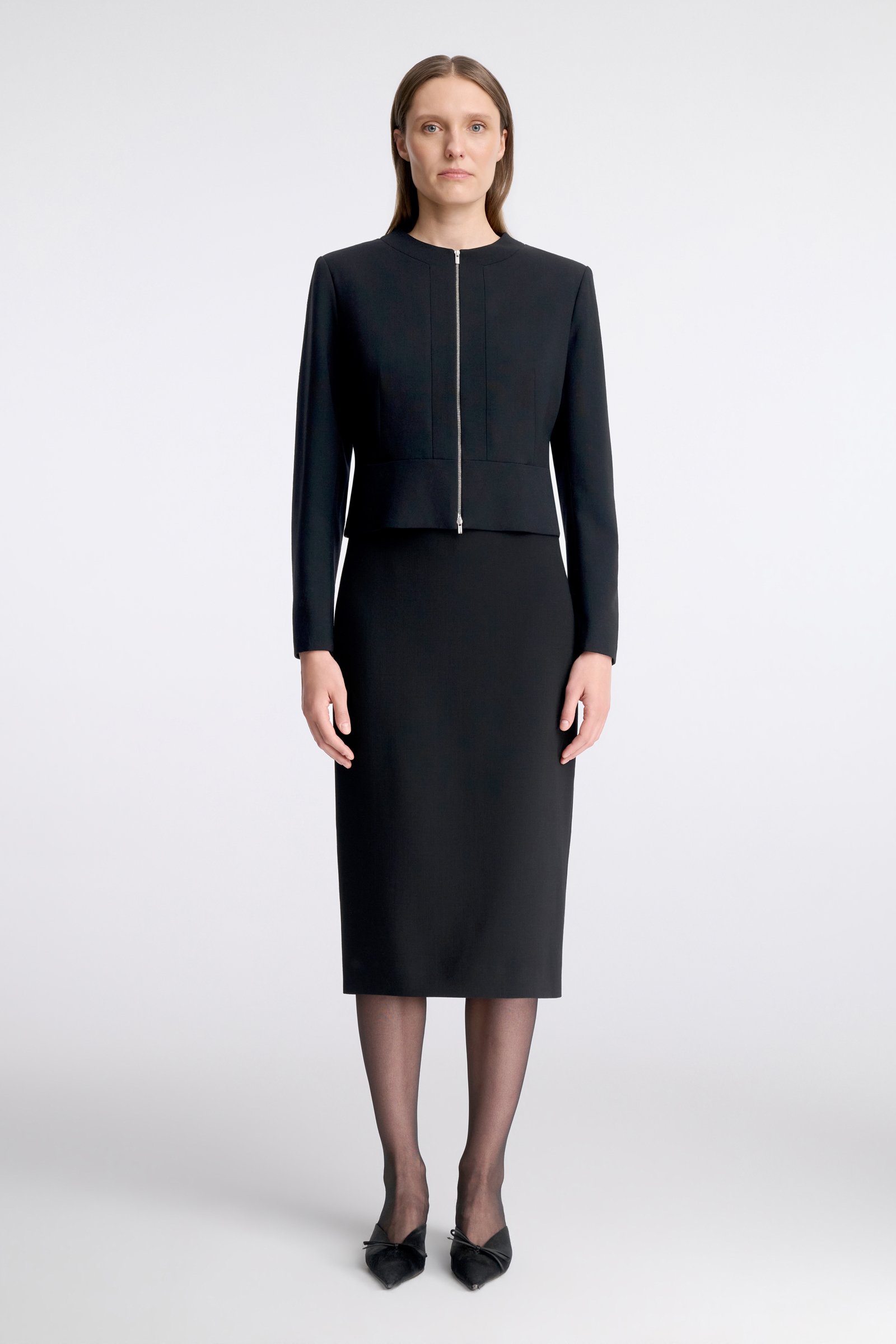 1084/B6 A black, short wool jacket with a zip fastening